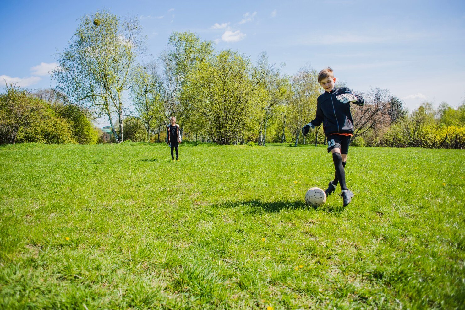 happy-child-playing-soccer_23-2147636776